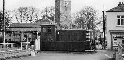Drewry shunter No. D2202 shunts the Outwell yard in front of St. Clements Church in 1958