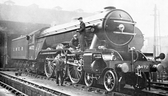 Driver Sparshatt standing infront of Gresley A1 Pacific No. 4472 'Flying Scotsman' at Kings Cross